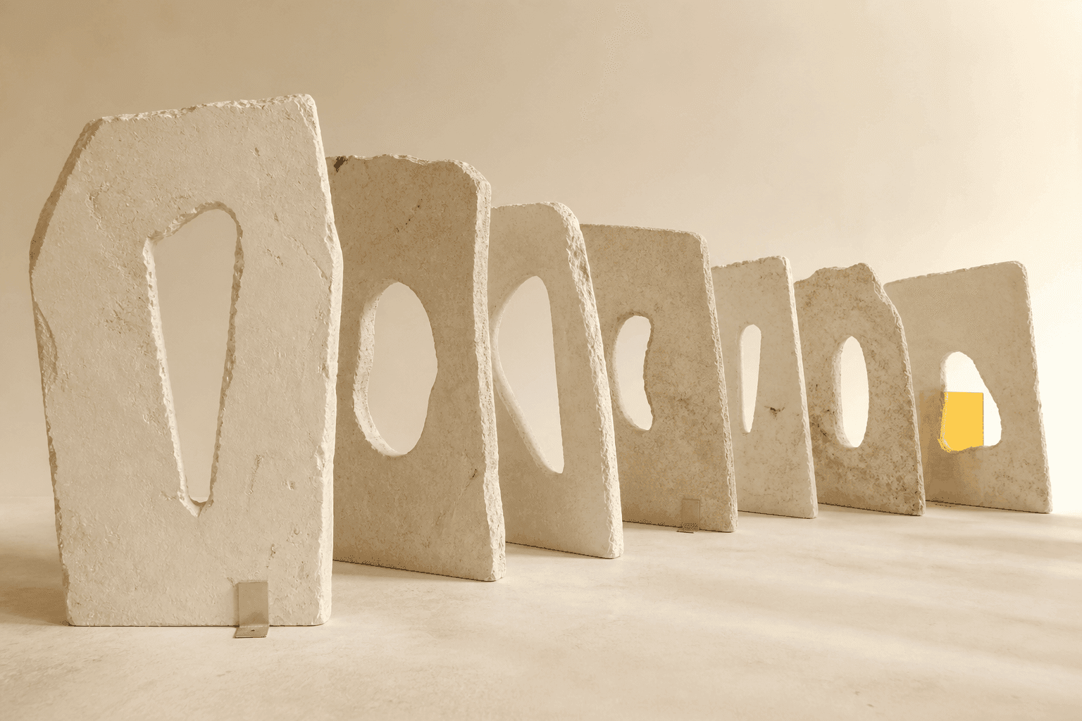 Generated illustration showing a deep sequence of ivory mineral slabs with different cut-out openings, lit by a small amber glass pane at the back.